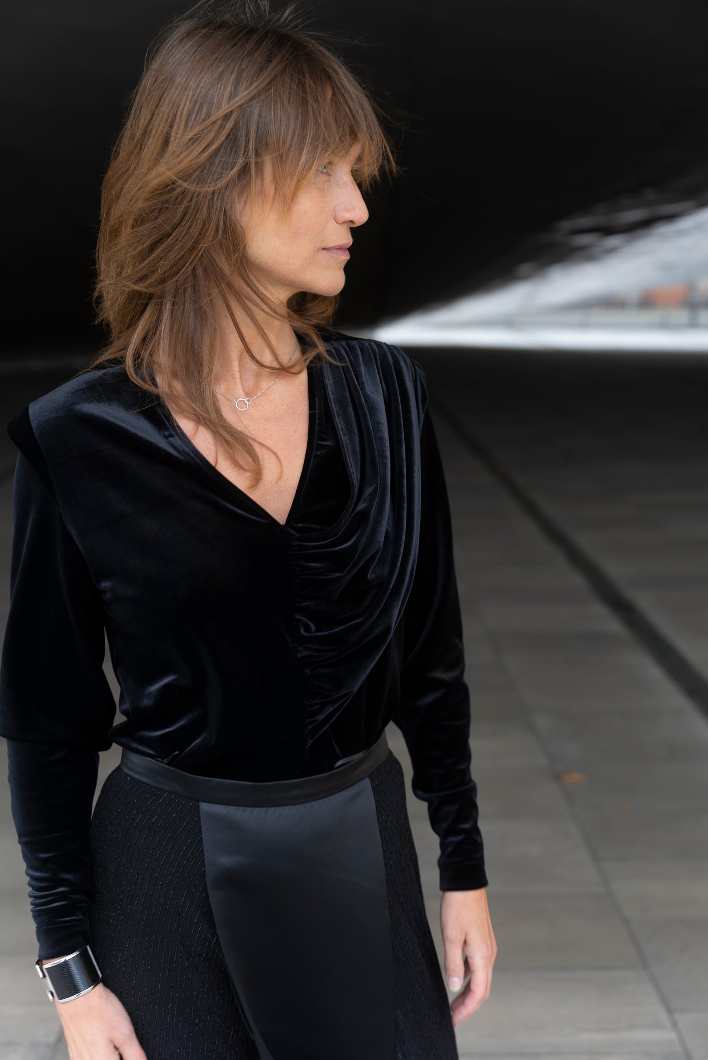Woman wearing Alek top mathced with Aya skirt - all in black.