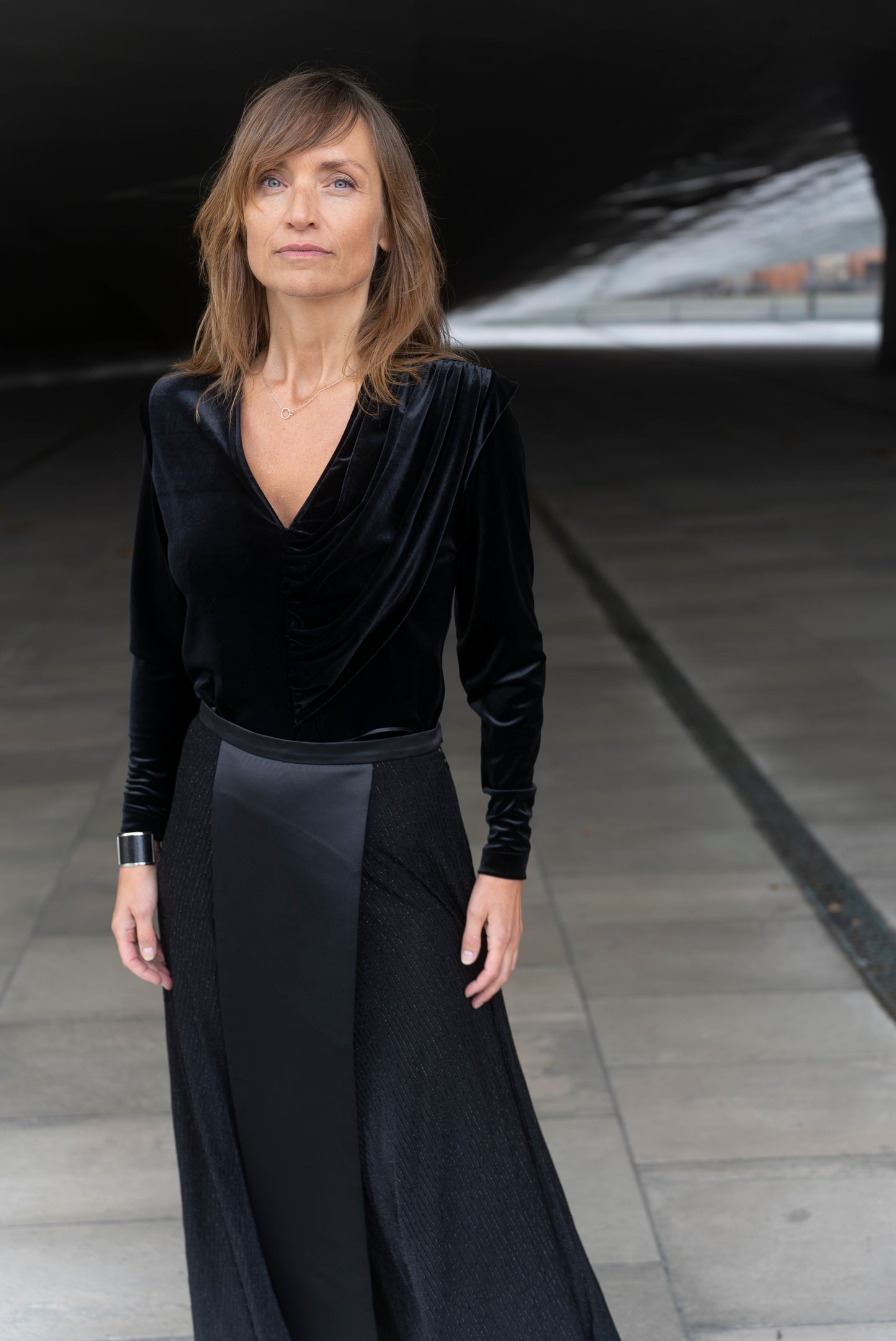 Woman wearing Alek top mathced with Aya skirt - all in black.