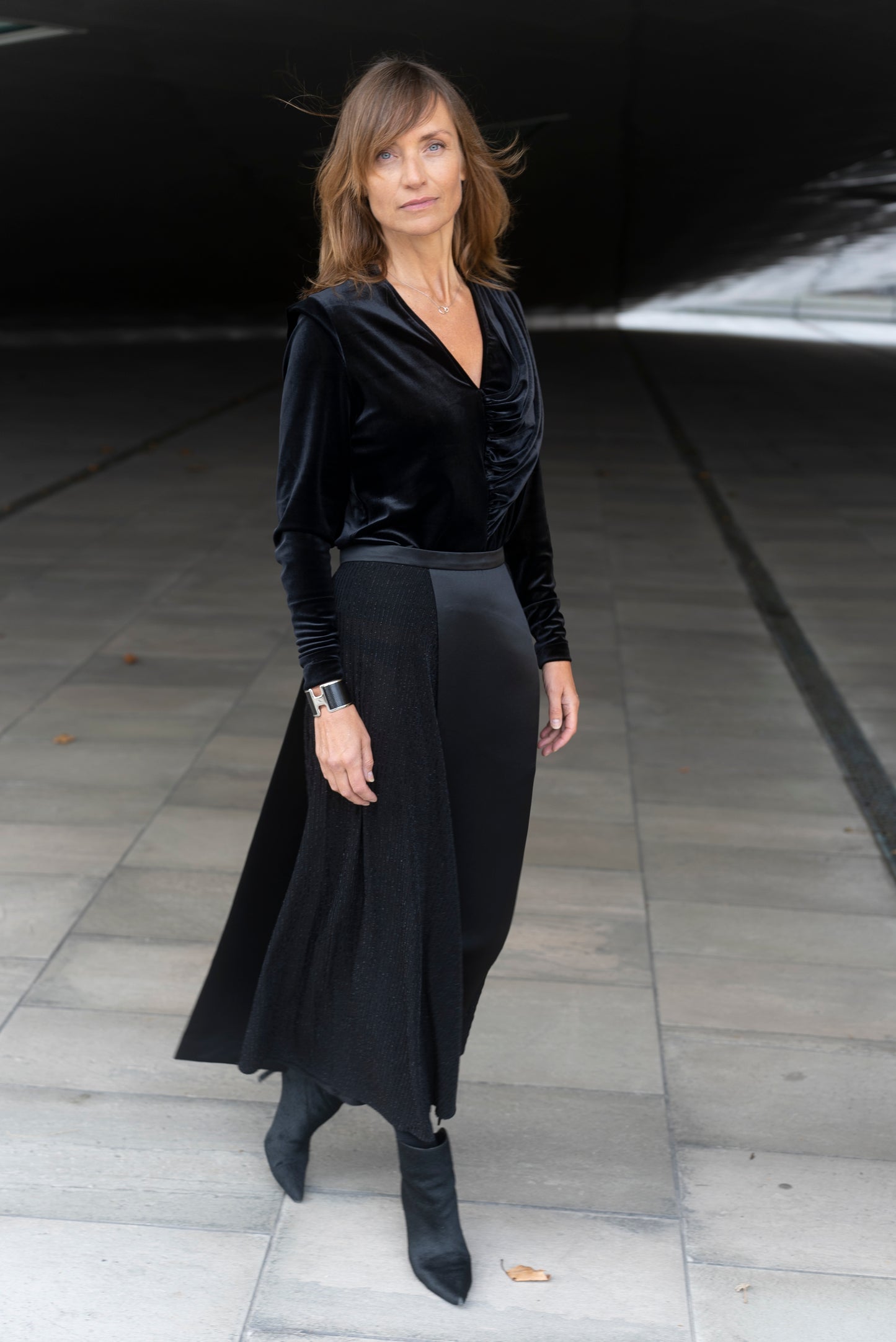 Woman wearing Alek top mathced with Aya skirt - all in black.