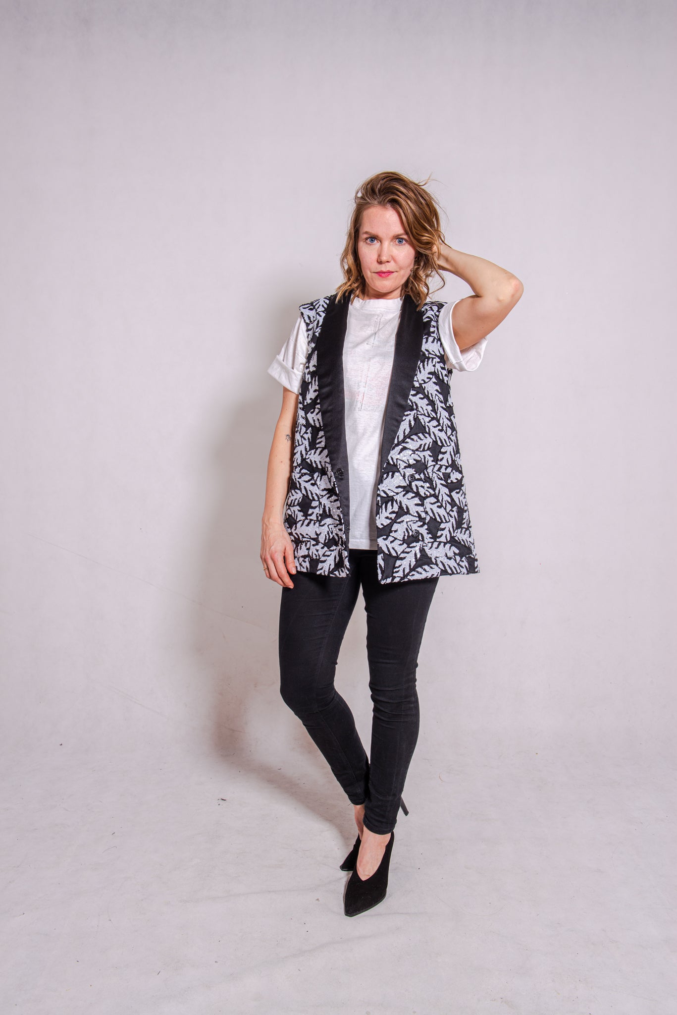 Woman wearing Alison - a double-breasted sequin gilet.