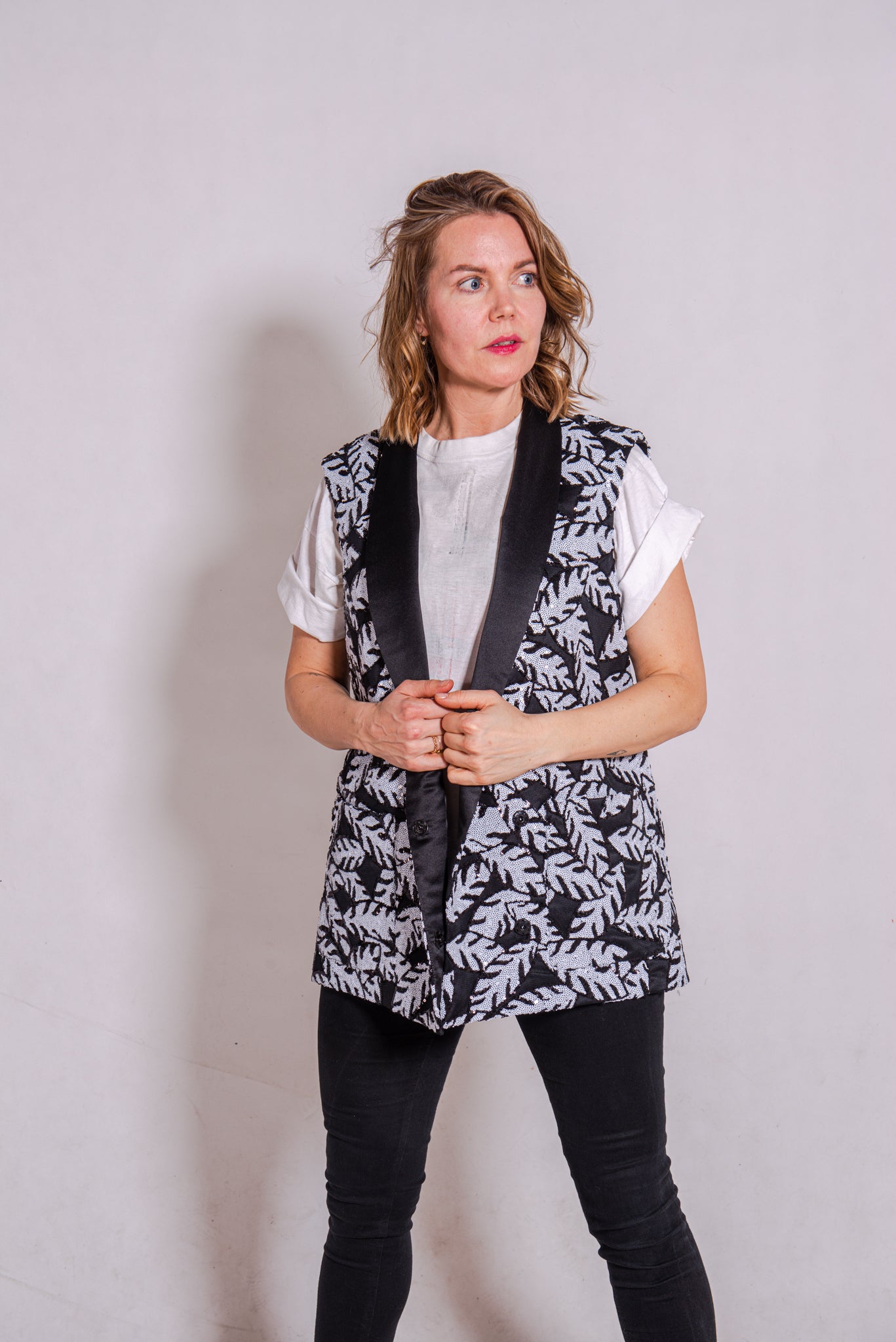 Woman wearing Alison - a double-breasted sequin gilet.