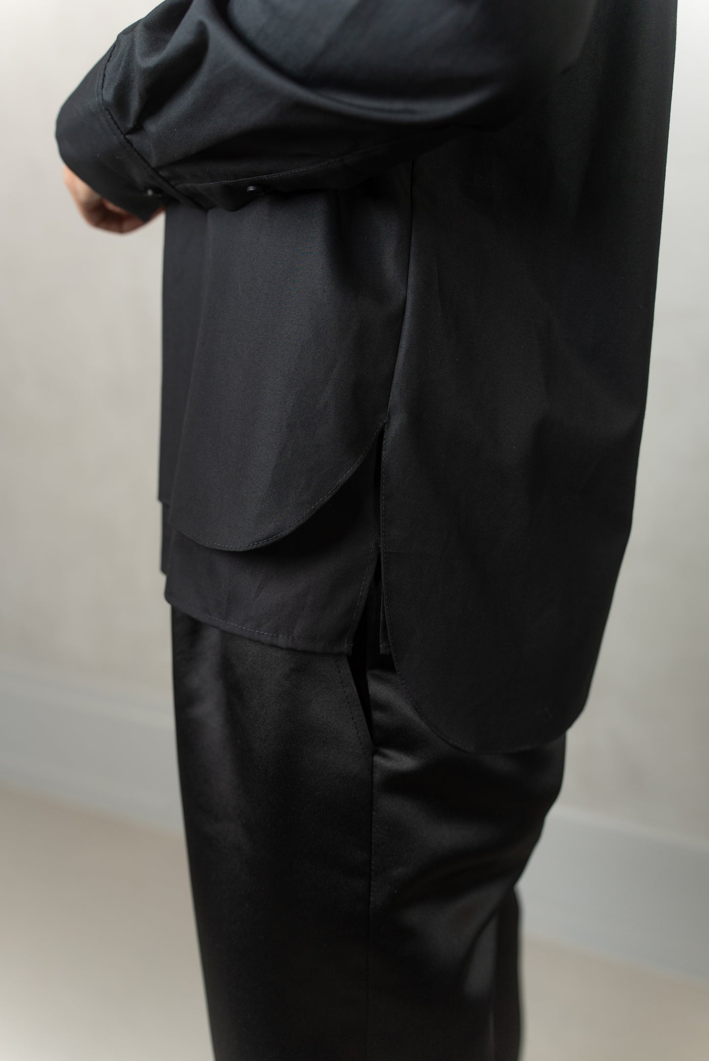 Detail view of Abbey shirt black side & Agnes trousers (black)