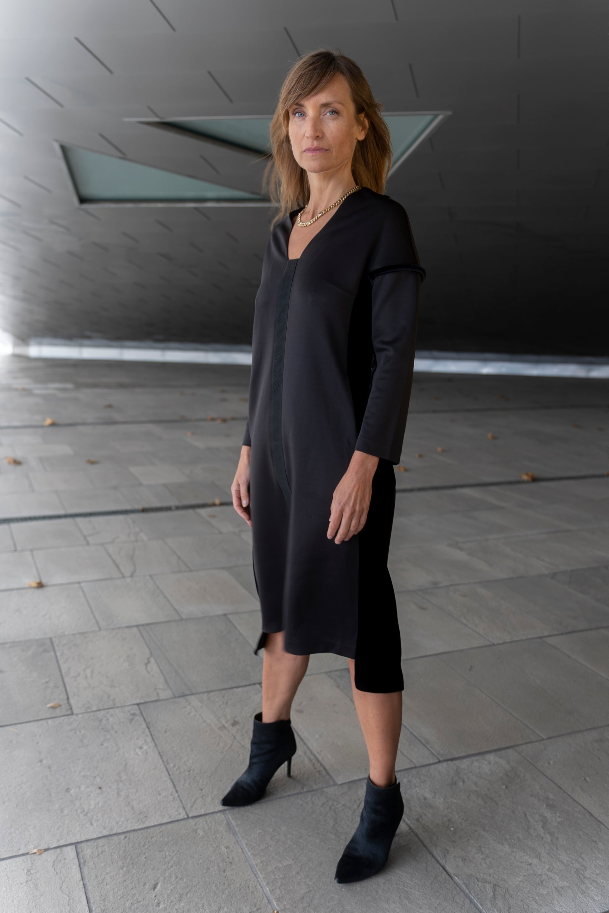 Woman wearing Adisa dress in black.
