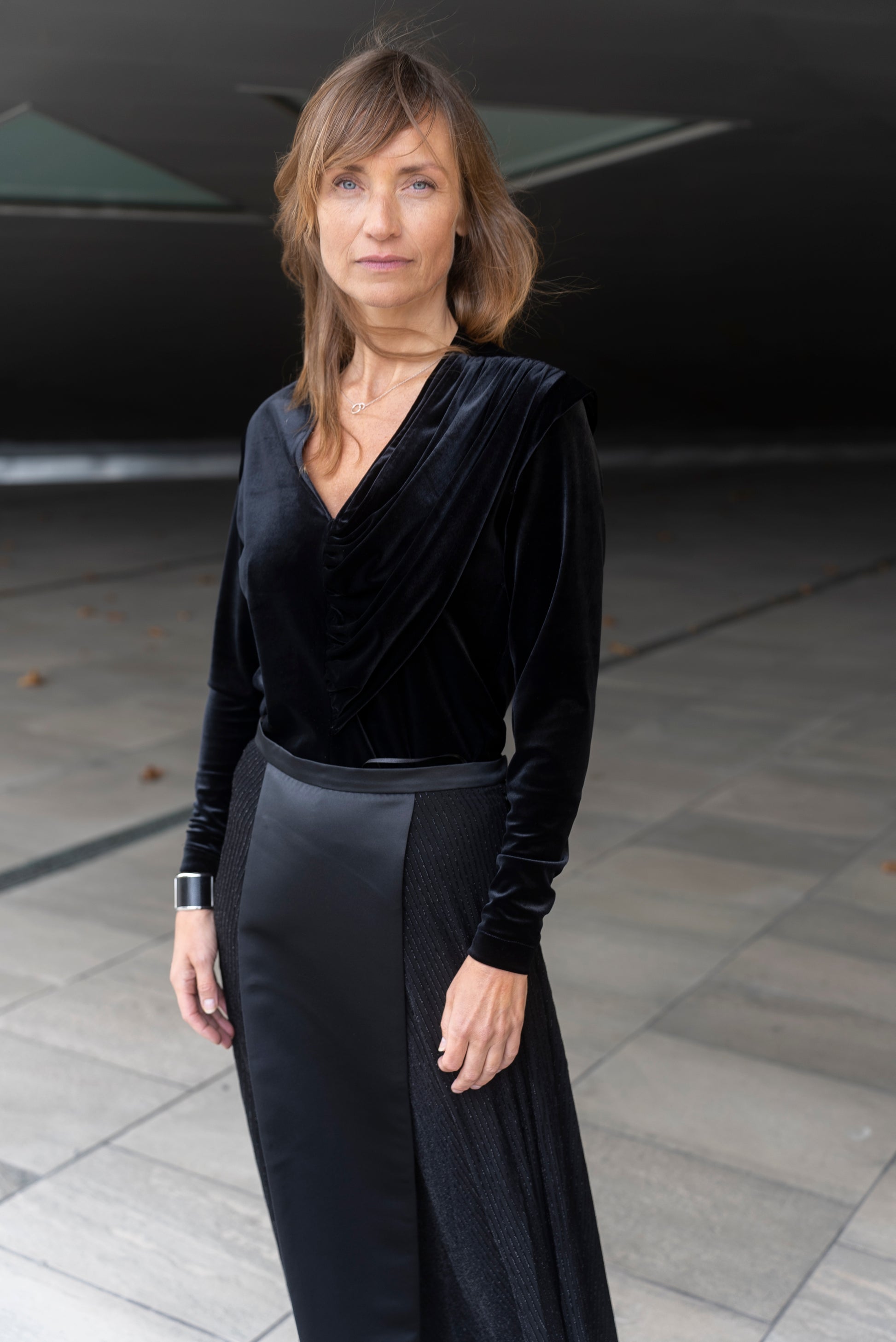 Woman wearing Alek top mathced with Aya skirt - all in black.