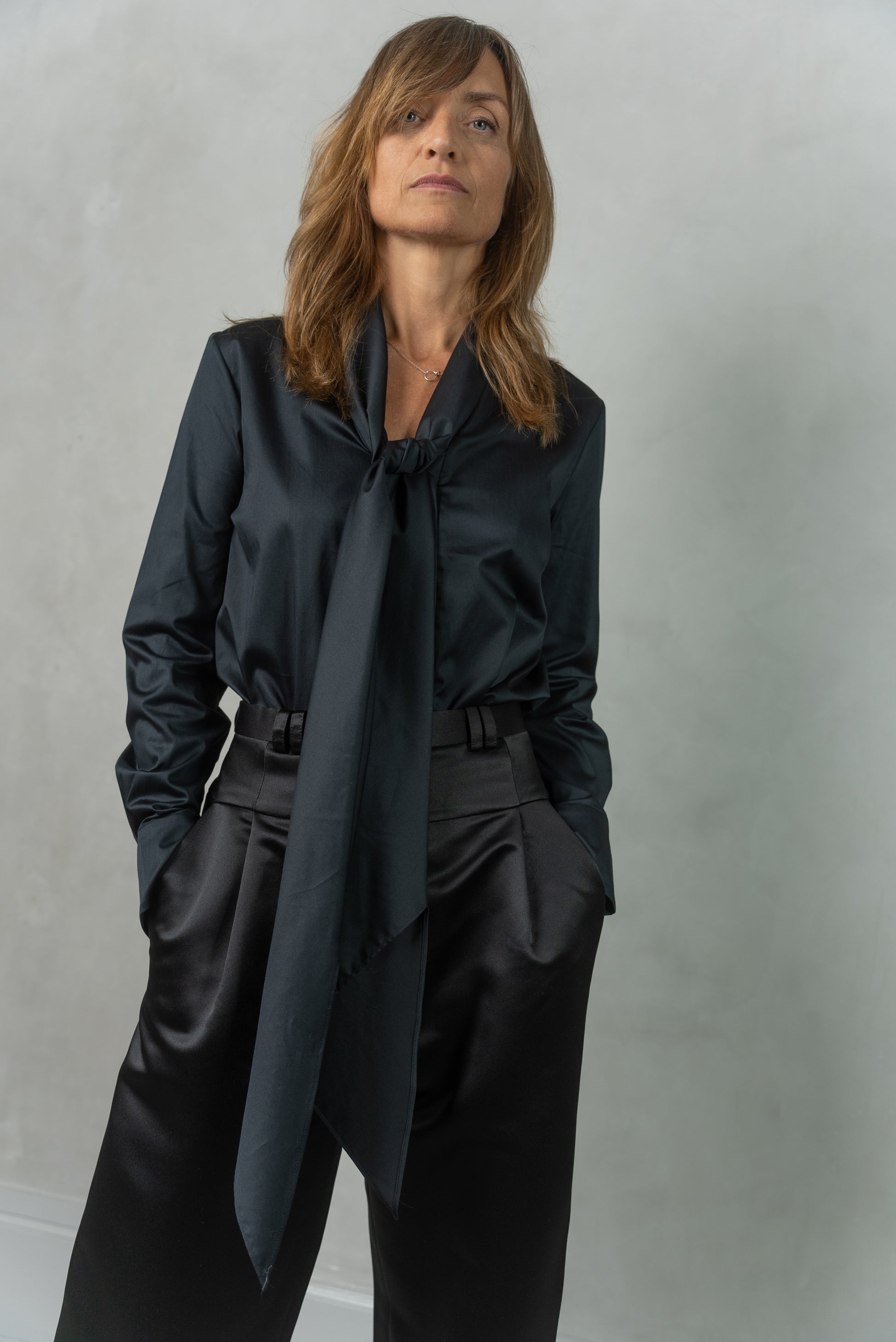 Woman wearing Alina shirt in black matched with Agnes trousers in black.