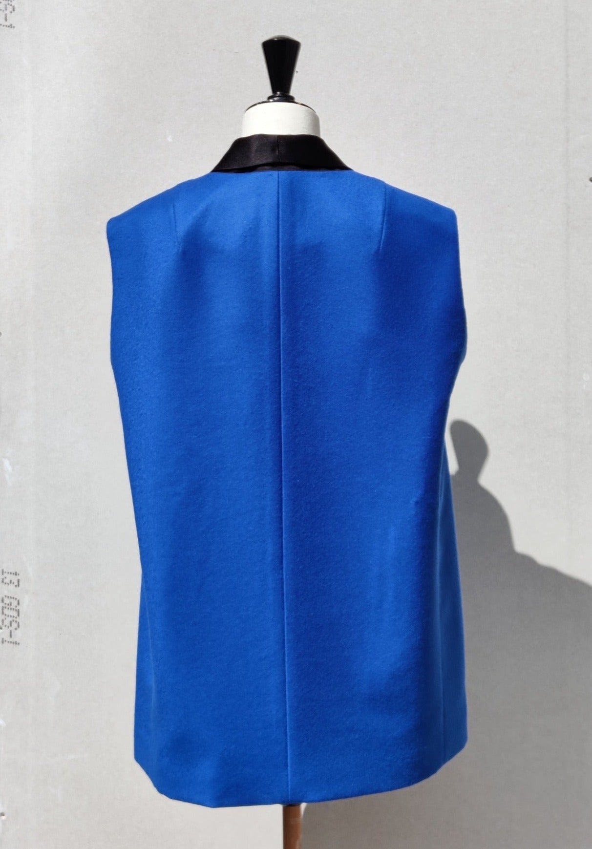 Alson Gilet, blue wool, on a dummy. Back view.