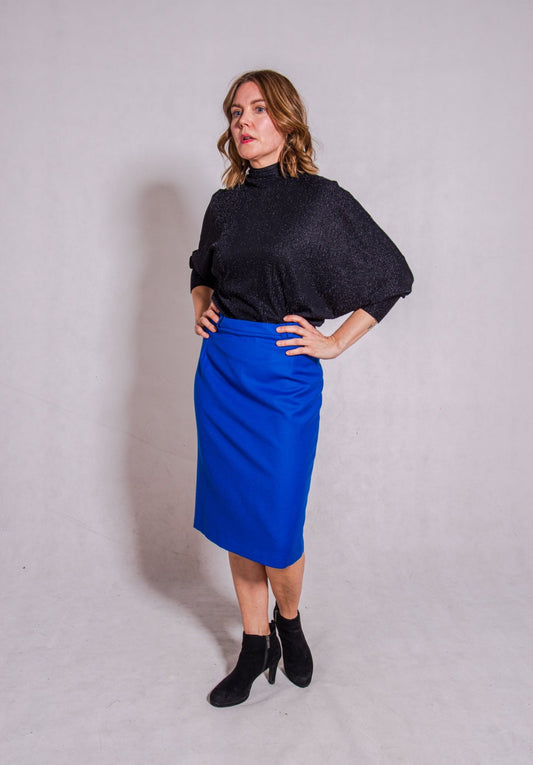 Woman wearing Adriana top with Ava skirt in blue wool.