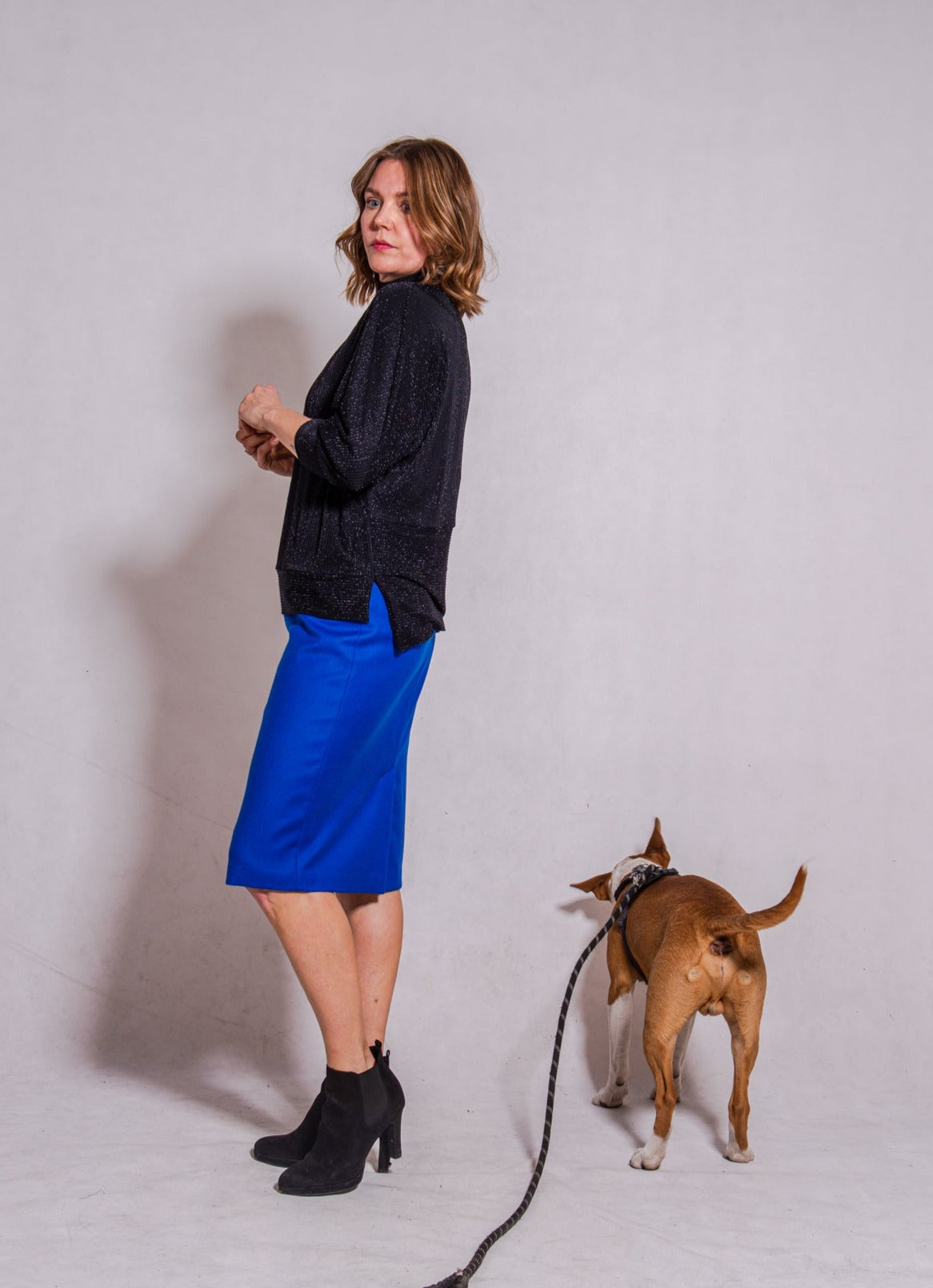 Woman wearing Adriana top with Ava skirt in blue wool.