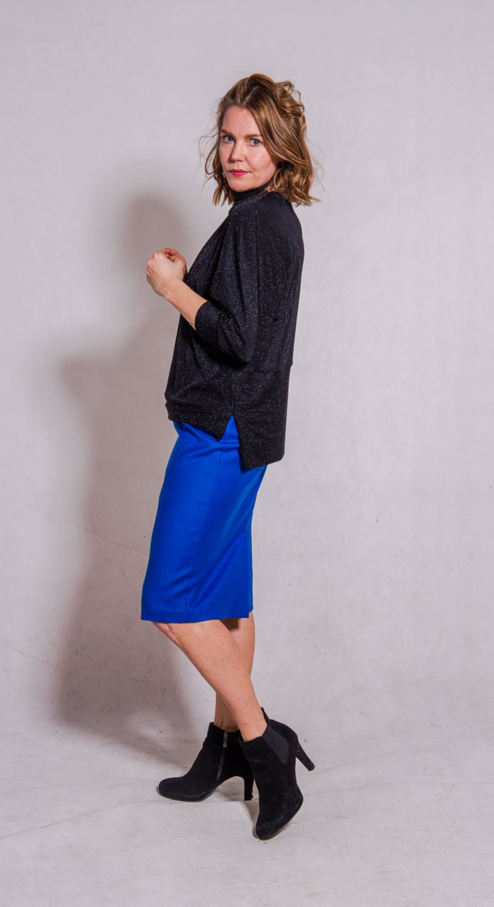 Woman wearing Adriana top with Ava skirt in blue wool.