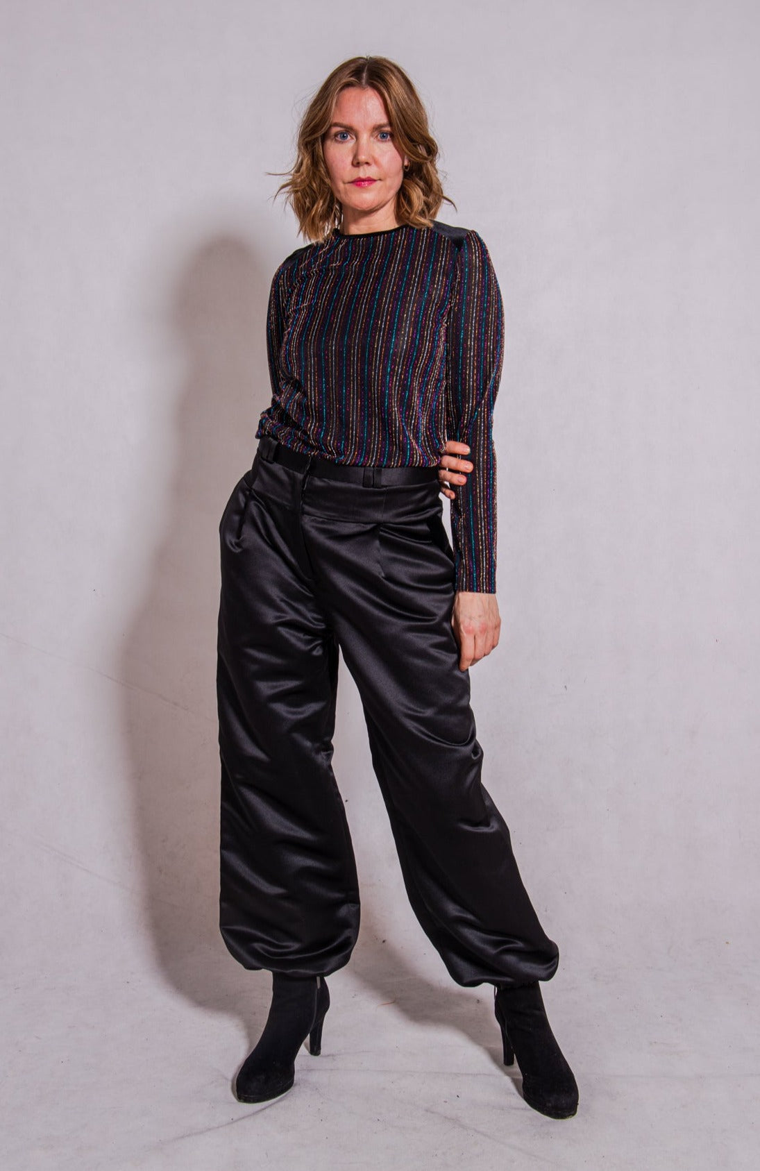 Model front facing wearing Ailo top stripey multi paired with Agnes trousers in black