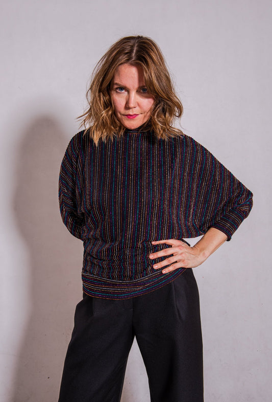 Model looking direct wearing Adrianna top, stripey multi & Ava trousers, black.