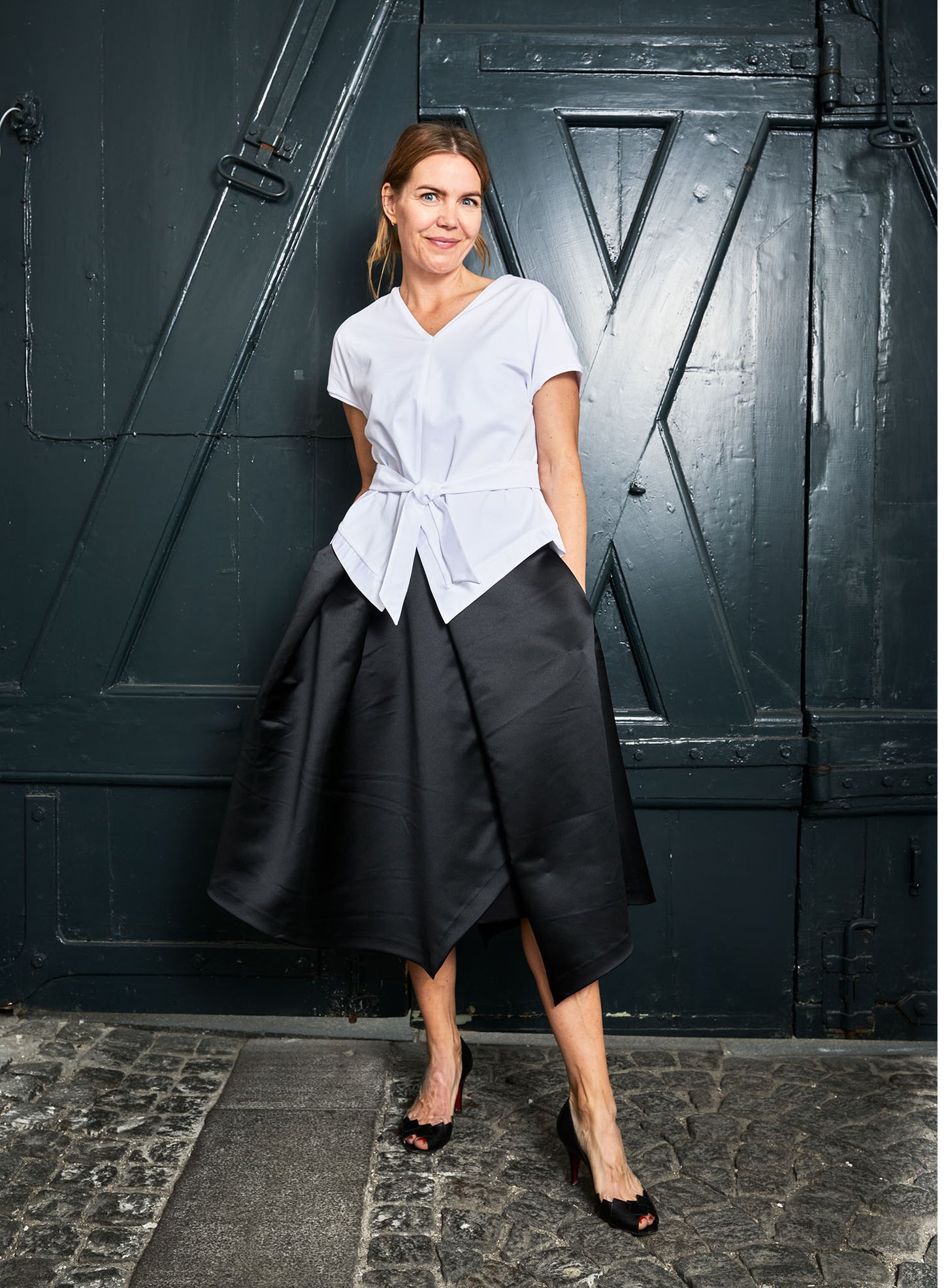 Aider shirt (white) is cut in a silk touch cotton-jersey with a handkerchief silhouette and added cotton detail on the hem line. Paired here with the ALYZA skirt (black))