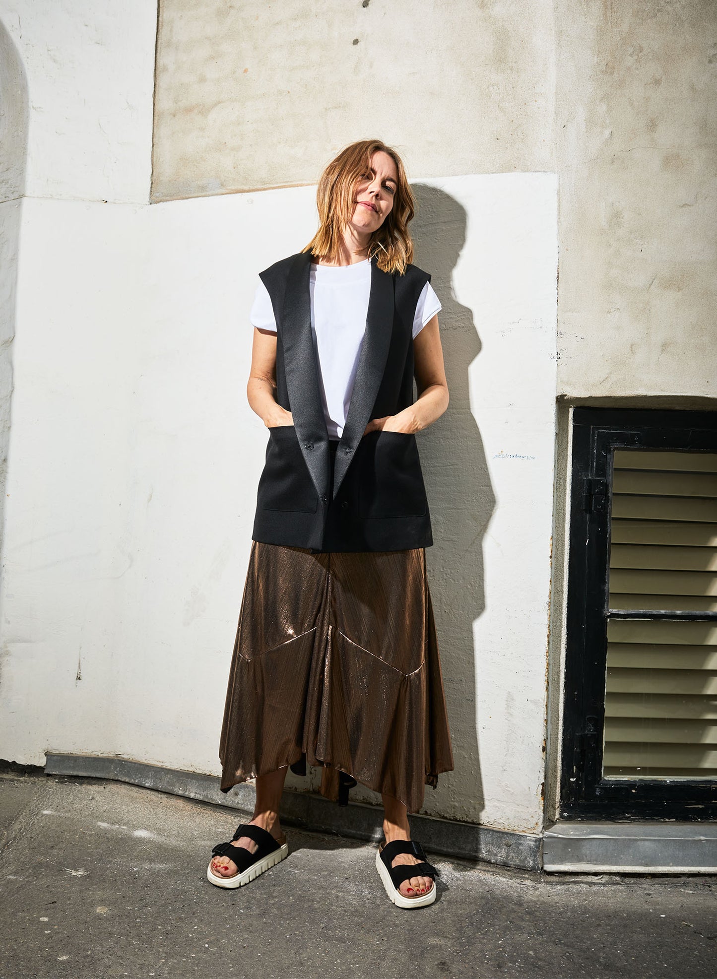 Woman wearing Alison black matched with The Alyza skirt (bronze).